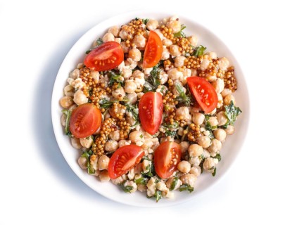 Vegetarian salad of boiled chickpeas, cheese, arugula, mustard and cherry tomatoes isolated on