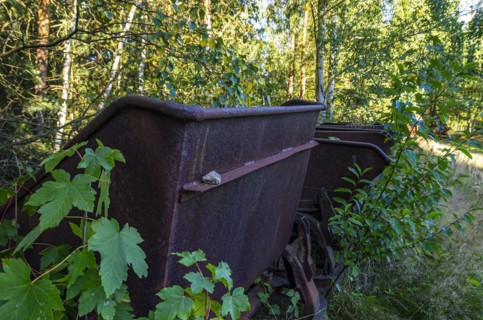 Old dilapidated rusty wagons of a light railway in an abandoned quarry, West Lusatia, Saxony,