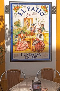 Ceramic tile picture of traditional folk musicians at El Patio restaurant, Triana district,