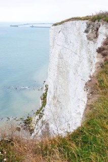 Steep, almost vertical cliff, chalk cliffs above the sea, an example of erosion in a coastal