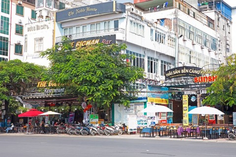 Mopeds and restaurants on the harbour promenade of Cat Ba Town, Cat Ba Island, Halong Bay, Vietnam,
