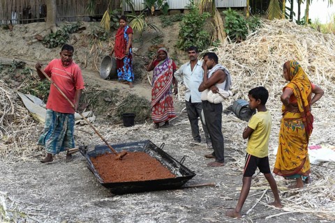 Workers making Gur (jaggery) in a village on December 10, 2021 in Barpeta, Assam, India. Gur