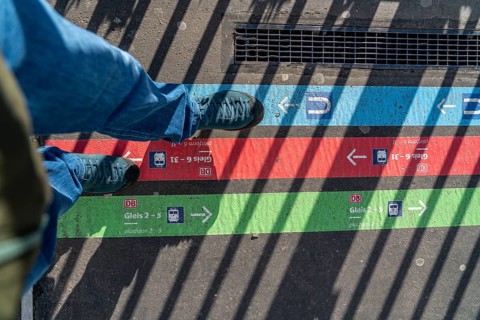 Signpost on the pavement, for bus and train diversions at Dortmund Central Station, during