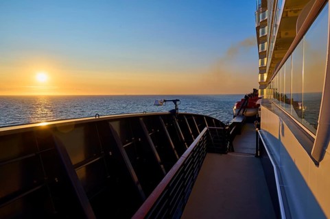 Deck of a ship at sunrise with clear sky and blue railing, Mein Schiff 6, North Sea, Denmark,