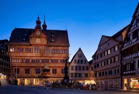 Historic town hall, illuminated, Neptune fountain, market square, in summer, people relaxing in