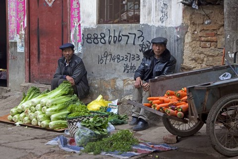 Chinese vendors selling vegetables on the street in the city Zhaotong, Yunnan province, China, Asia