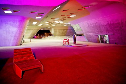 The colourfully illuminated phæno building, an experimental landscape and a science centre in the