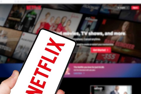 Netflix logo online video streaming platform on a mobile phone and computer in Stuttgart, Germany,