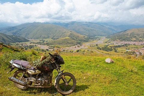 View of the Combapata district and the Rio Vilcanota in the Andean highlands, in front a motorbike,