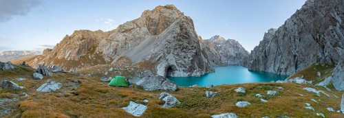 Wild camping, camping in the wilderness with a tent in front of mountain lake Kol Suu, Sary Beles