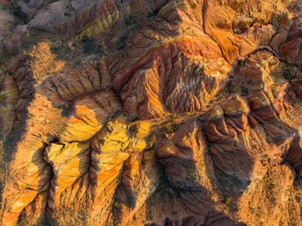 Aerial view, eroded mountain landscape, sandstone cliffs, canyon with red and orange rock