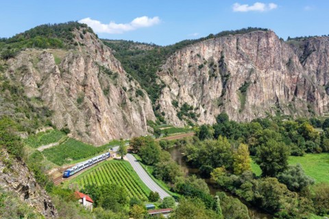 The Rotenfels with an Alstom Coradia LINT regional train operated by Vlexx in Traisen, Germany,