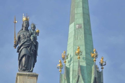 Madonna figure with golden crown and blurred spire of Our Lady, Minster, sceptre, baby Jesus, arm,