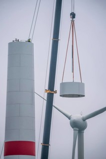 Construction of the tower of a wind power plant in a wind farm near Issum, 9 older wind turbines