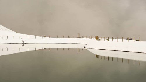 After snowfall in May: Riezler Alpsee, an artificial lake, snow pond, feeds the snow cannons that
