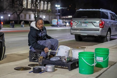 Detroit, Michigan - A street musician performs on his pots and pans on Noel Night. The annual event