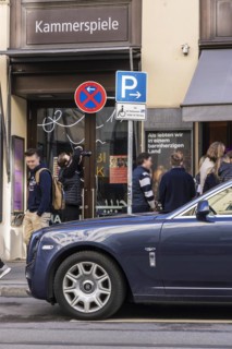 Disabled parking space in front of a trendy bar on the fashionable shopping street Maximilianstraße