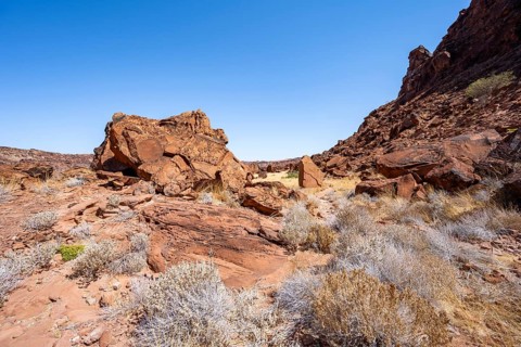 Barren landscape with red boulders in a valley, desert landscape, Twyfelfontein, Kunene, Namibia,