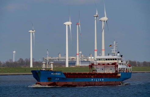 Cargo ship in the Ems estuary, wind turbines, Lower Saxony, Germany, Europe