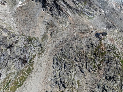 Mountain hut Cabane de Moiry, serpentines of hiking trail, aerial view, Valais, Switzerland, Europe