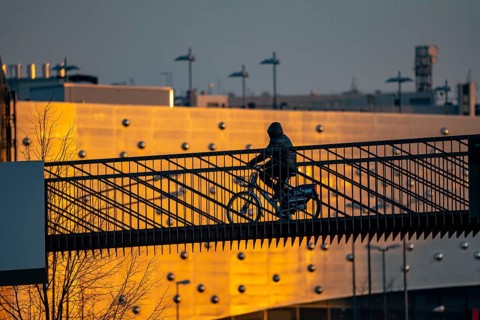 Cyclist on a bridge over Segerothstraße, in Essen, behind Limbecker Platz shopping centre
