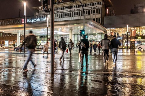 Passers-by at a pedestrian crossing, at the main railway station, rainy weather, city centre, in
