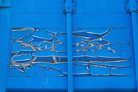 Close-up of cracked and peeling blue paint on metal shipping container, Quebec, Canada, North