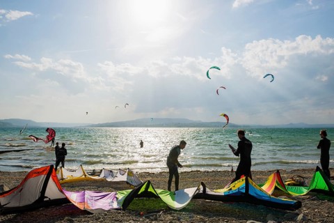 Kitesurfers and windsurfers in sun and storm, Reichenau Island, Untersee, Lake Constance,