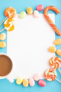 Composition with candies frame on blue pastel background. copy space, top view, flat lay, template