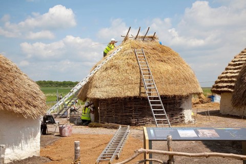 Buildings of replica Neolithic huts at the Stonehenge site, Wiltshire, England, UK