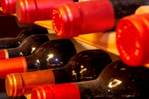 Wine cellar with red wine bottles