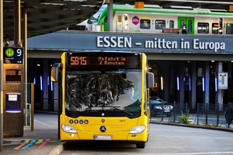 Essener Verkehrsbetriebe bus at the main railway station with local train, public transport,