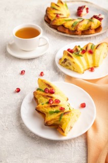 Cheesecake with cup of green tea on gray concrete background and orange linen textile. side view,