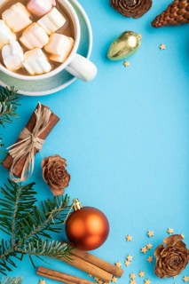 Christmas or New Year composition. Decorations, box, cinnamon, cones, fir and spruce branches, cup