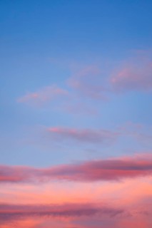 Blue sky with pink-coloured clouds at sunset