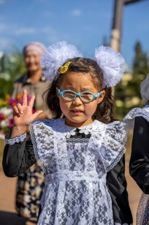 Cool schoolgirl on her first day at school, Issyk-Kul region, Kyrgyzstan, Asia