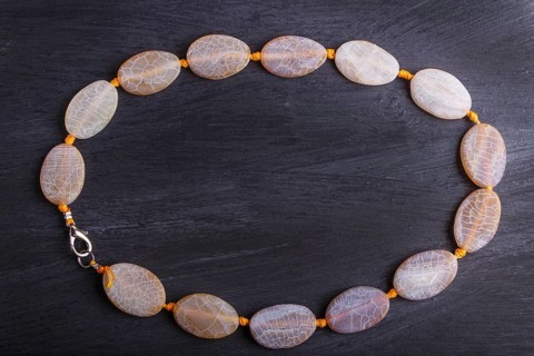 Dragon vein agate colored beads on a black background. top view, close up
