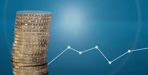 Stacked euro coins against a blue background
