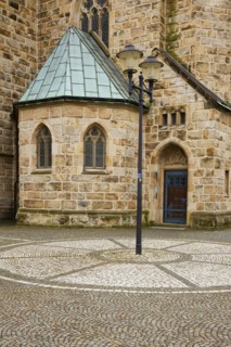 Cobblestones and lantern with part of St Laurentius Church in Warendorf, Warendorf district, North