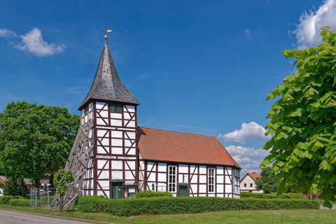 Half-timbered church in Wenze, stabilised against collapse with squared timbers, in the UNESCO