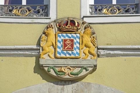 Coat of arms with lion figures, crown and post horn, market square, Feuchtwangen, Middle Franconia,
