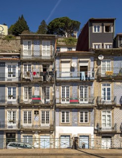 Front facades of narrow houses in the historic center near the Douro river in Porto, Portugal,