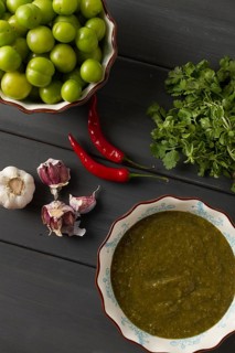 Tkemali sauce, traditional Georgian cuisine, green cherry plum, with ingredients for sauce,