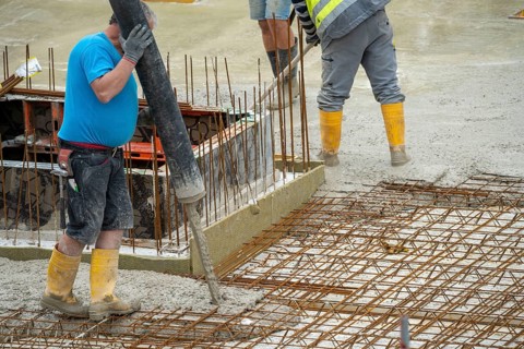 Construction site, concreting, the floor slab of a building is concreted, the concrete is pumped