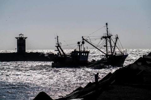 Fishing vessel TH10 DIRKJE, off the coast of Scheveningen, The Hague, with spread nets, beacon of