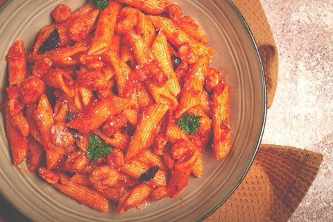 Penne pasta, with shrimp in tomato sauce, close-up, no people
