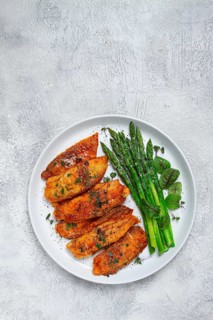 Fried fish fillet, tilapia with asparagus, homemade, no people