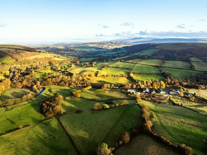 Farms over Trecastle from a drone at sunset, Brecon Beacons National Park, Powys, Wales, England,