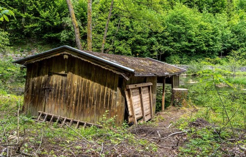 Small pond with dilapidated wooden shed in the water, Bad Reichenhall, Bavaria, Germany, Europe