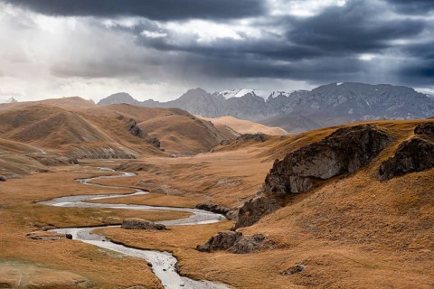 River in front of mountain landscape with yellow meadows, Kol Suu River and mountain peaks, Keltan
